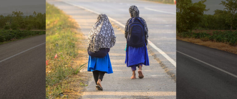 School girls walking on a road