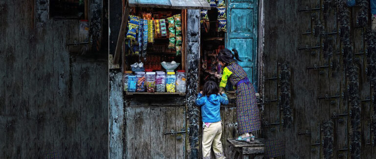 Two children at a shop